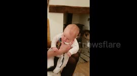 Newsflare Edit - Four-week-old baby slightly put out at dad's sneeze