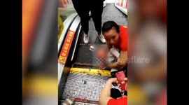 Where are the parents? Toddler LYING DOWN on escalator gets hand stuck