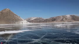 Incredible footage shows two Brit adventurers walking across one of the world's biggest frozen lakes
