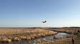 Water Bombers buzz crowd and refill on Canadian lake.