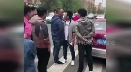 Man suddenly kisses opponent during face-off in middle of street