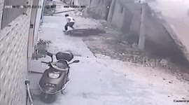 Scooter driver narrowly escapes being buried under collapsed wall