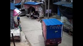 Three-wheeler started up by 9-year-old girl crashes into stall, tips over and flattens boy