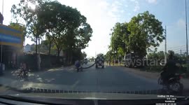 The man sat on the long iron rods moving behind the truck
