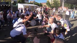 Fans of Real Madrid sing in the fan zone near the