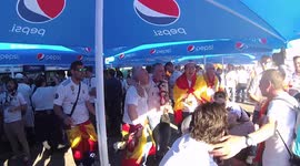Fans of Real Madrid are singing in the fan zone near the