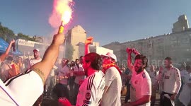 Fans of Real Madrid are burning fireworks and singing in the fan zone near the