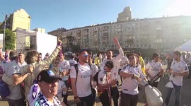 The fan of Real Madrid pours from the bottle to the film crew in the fan zone next to the Palace of Ukraine in Kiev before the start of the Champions League final in Kiev, Ukraine.