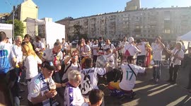 Fans of Real Madrid are singing in the fan zone near the