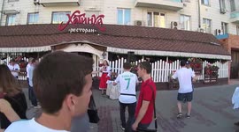 A girl in Ukrainian national clothes sings the song