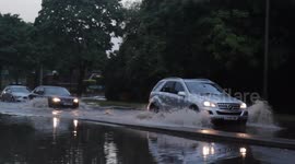 Ducks paddle across flooded road in Birmingham