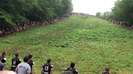 Man bares almost all in daring cheese rolling attempt