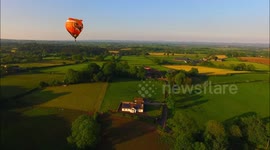 Drone camera captures hot air balloons at sunset