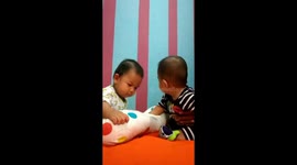 Two babies play together