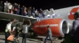 Shocking moment passengers leap from plane after bomb scare
