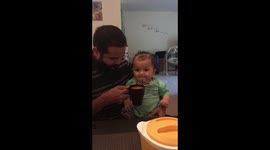 Baby tries orange juice for the first time and enjoy with smile on his face (2018)