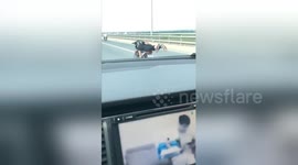 Man performs 'Superman' motorcycle stunt while speeding down motorway