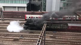 Steam Train pulling out of Paddington Station, shot from above with modern tube train moving in opposite direction