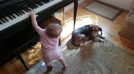 Famous dog works on his vocal warmups, while his baby sister plays