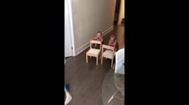 Twins infants pushing chairs