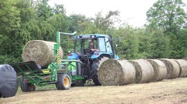 Irish farmer wraps bales of hay in plastic
