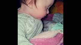Very tired sleepy baby finally passes out.