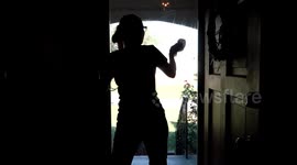Woman washes window and dances to music