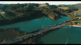 Shelly Beach and Causeway road drone backward fly waiheke island