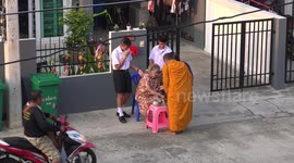 Thai Buddhist monk collects alms.