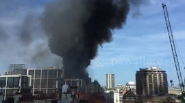Top shot of thick black smoke rising above Mandarin Oriental fire