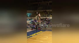 Newsflare Edit - Players standing on hoops in amusing basketball game