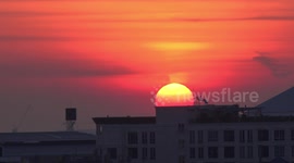 Airplane flies through gorgeous sunrise sky