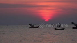 Thai fishing boat sails into the sunset