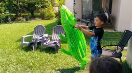 Boy playing with inflatable gator doesn’t realize real one is lurking nearby