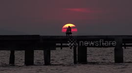 A photographer takes photos of an amazing sunset.