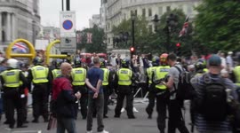 people throwing missiles on protester gets hit The Police turn up in numbers to try and control the situation before angry protesters rush forward trying to attack the cops they back of regroup and rush forward and protesters scatter by jim connor