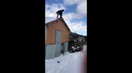 MAN JUMPS OF ROOF INTO SNOW SLOW MOTION