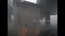 Portacabin blown across road in strong China winds