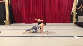 Girl shoots artow with her feet with contortionist on her back!!