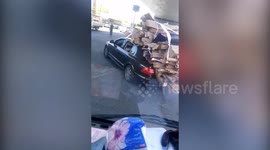 Chinese motorist carries a ridiculous amount of rubbish on top of luxury car