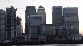 canary wharf at sunset from south south bank over the river Thames by Jim Connor