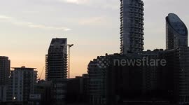 canary wharf at sunset from south south bank over the river Thames by Jim Connor