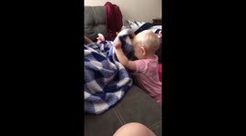 Baby plays peekaboo with daddy