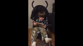 Cute baby laughing at his tablet