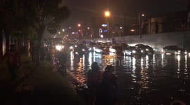 Cars stranded in flood water after tropical storm hits the Philippines