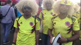Colombia fans dressed as Carlos Valderrama arrive for World Cup