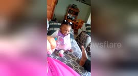 Baby laughs hysterically at her mums feet