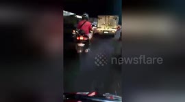 Newsflare Edit - Driver's moped blinds road users with strobe lights every time he brakes during Manila rush hour