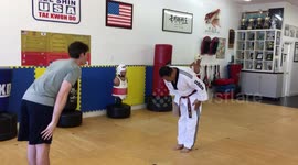 Man kicks through wooden board