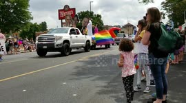 LGTB pridefest Denver Colorado on Colfax and Fillmore. Little girl waiving pride flag to the unicorn car